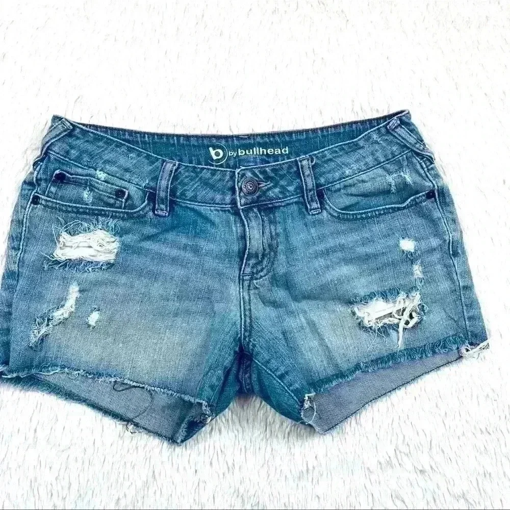 B By‎ Bullhead Med Wash Lowrise Distress Faded Cheeky Raw Hem Jean Shorts Size 9